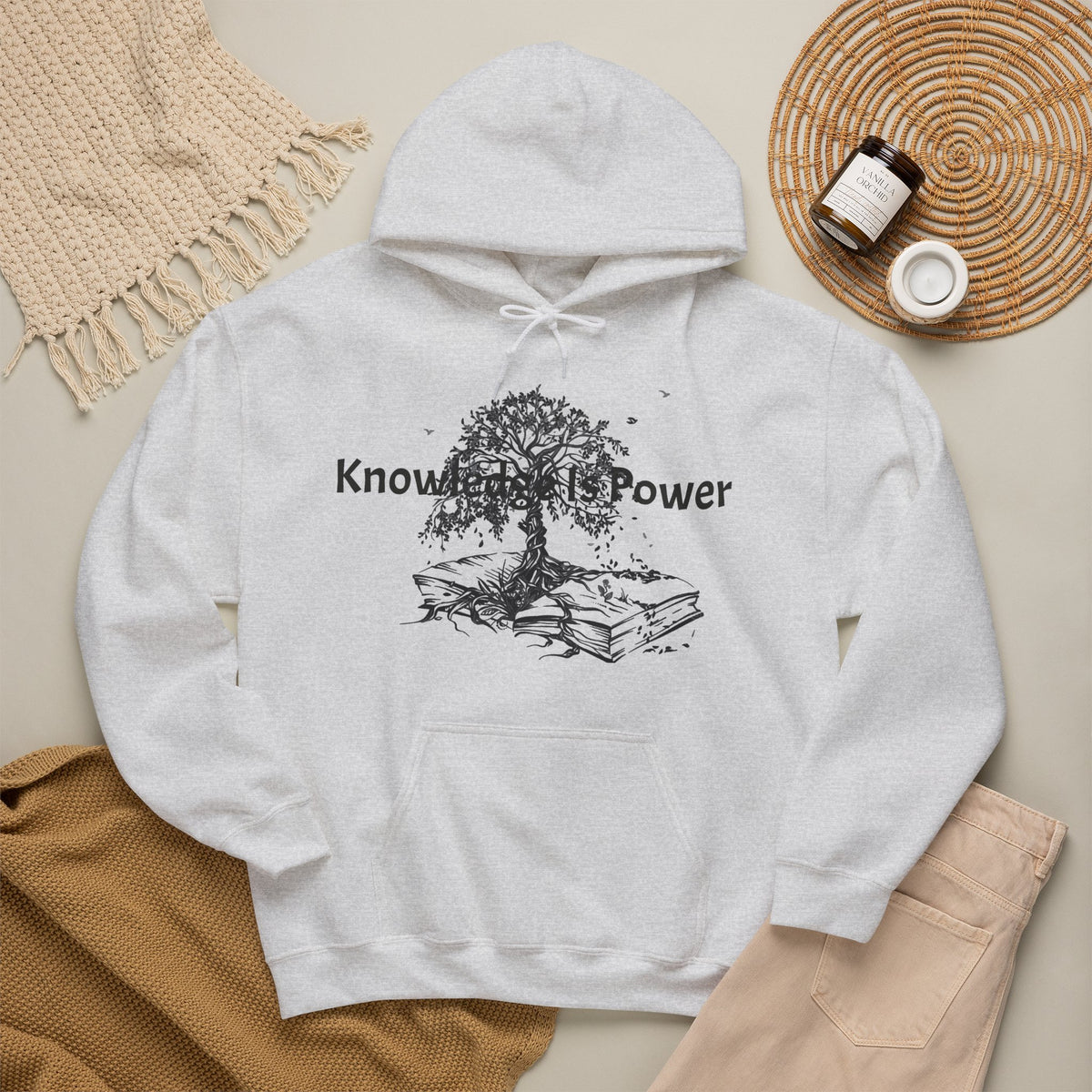 An Ash grey pullover hoodie with a kangaroo pocket and blue drawstrings, featuring a black graphic of a tree growing from stacked books with the words 'Knowledge is Power.' 