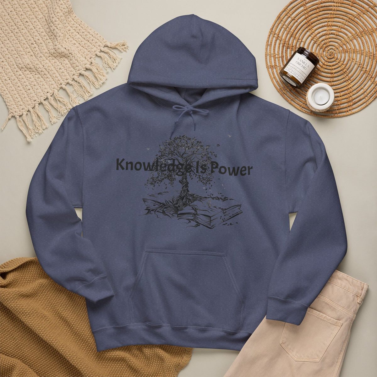 A Heather navy pullover hoodie with a kangaroo pocket and blue drawstrings, featuring a black graphic of a tree growing from stacked books with the words 'Knowledge is Power.' 